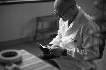 Nimbl artisan inspecting a performance cycling shoe in the Italian workshop