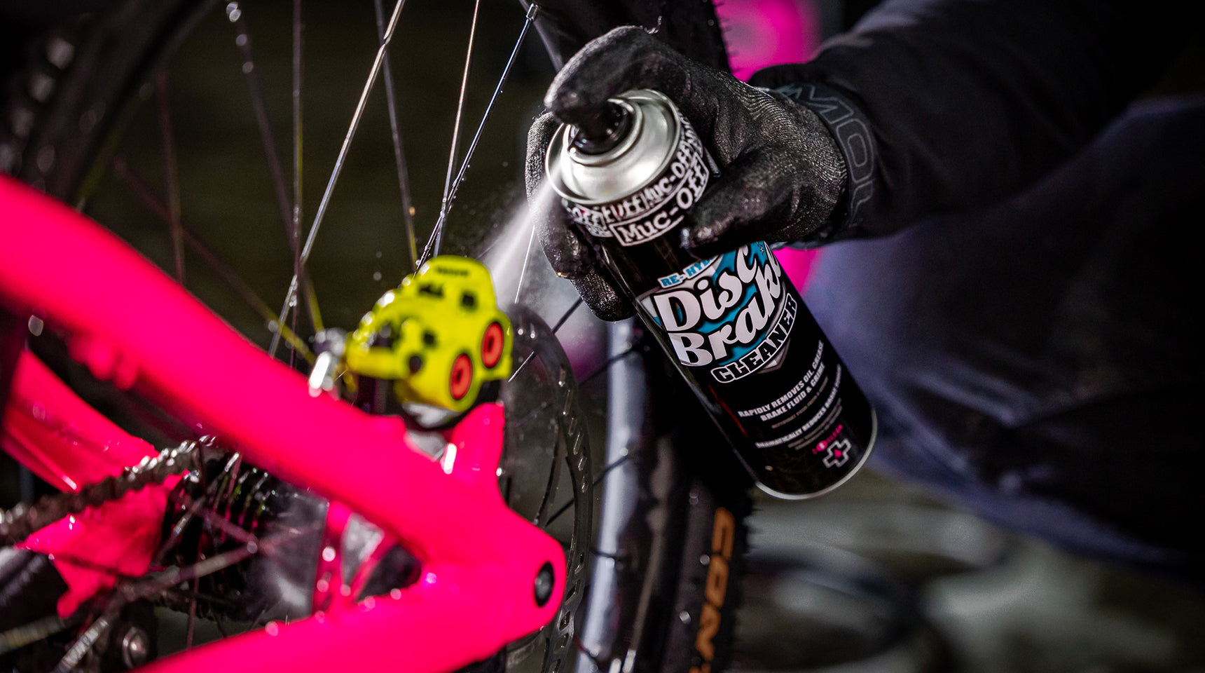 Close-up of Muc-Off Disc Brake Cleaner in use on bicycle brakes